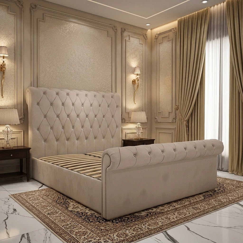 Beige upholstered sleigh bed with a tall diamond-buttoned headboard, matching rolled footboard, decorative stud edging and a wooden slatted base no mattress
