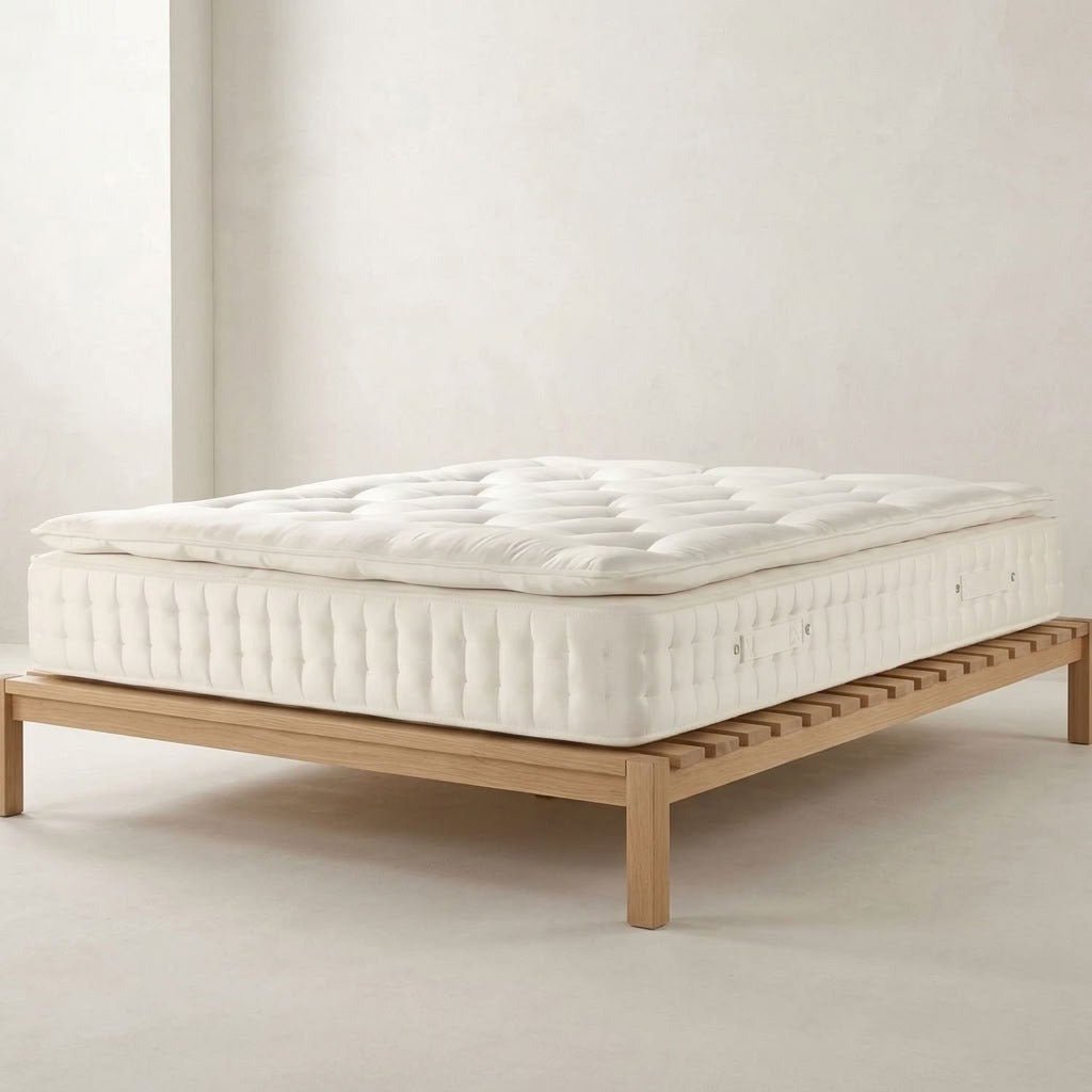 Dreamnap 3000 Pocket Pillow Top Mattress displayed on a light wooden slatted bed frame.