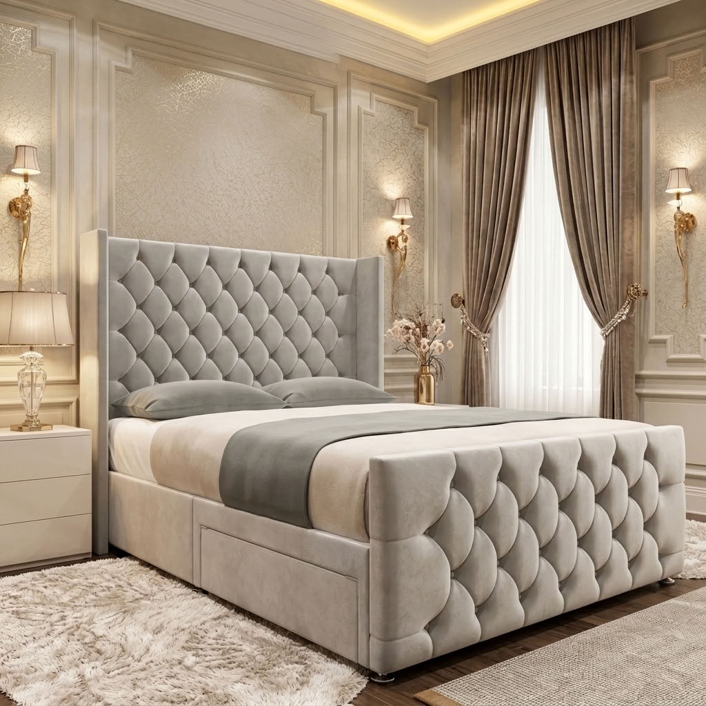 Light grey upholstered divan bed with a tall diamond-tufted winged headboard, matching footboard and padded side rails.
